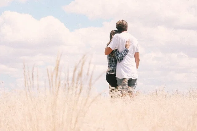 loving couple staring away on a empty field