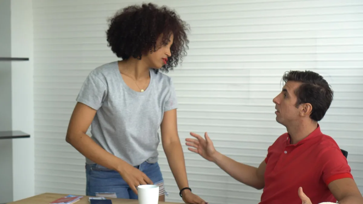 recover an awkward conversation — Couple arguing against wall at home