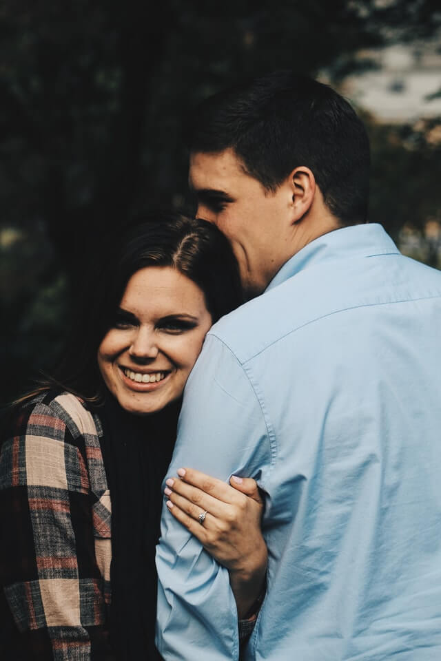 happy engaged couple posing for the camera