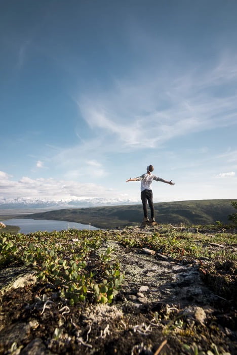 man in open field with open arms freedom self-love affirmations