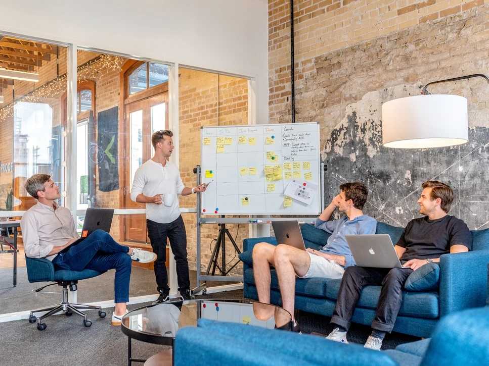 a group of people having a meeting about their schedule