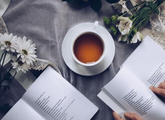 Reading a book while drinking tea