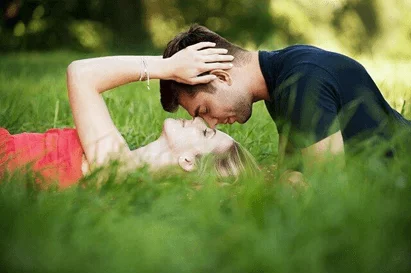 Man and woman facing each other while lying down