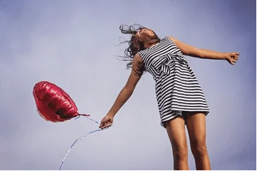 Woman holding a red heart-shaped balloon - paragraphs for her