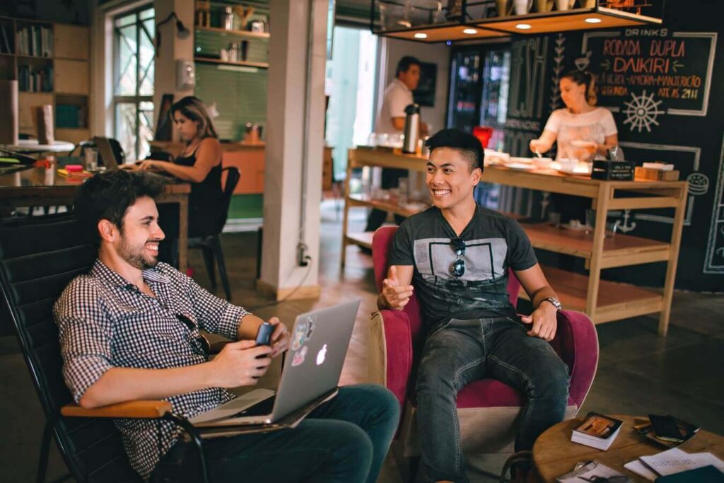 two men laughing at a coffee shop - Personal and professional development