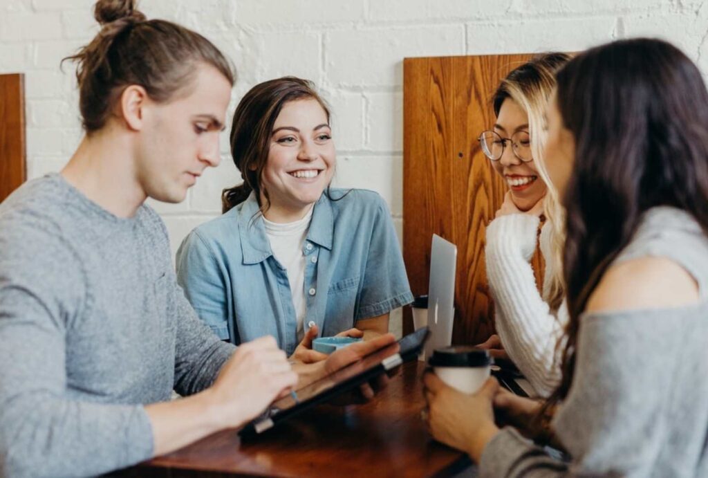 Group of people talking to each other over coffee