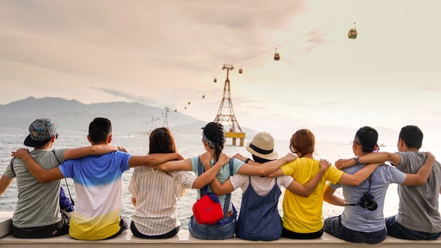 A group of people holding each other while sight seeing