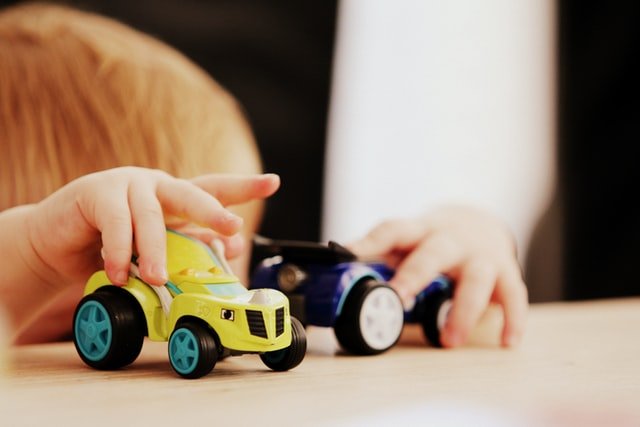 Child playing with two toy cars - Is it bad to be a shy person?